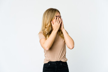 Young caucasian blonde woman afraid covering eyes with hands.