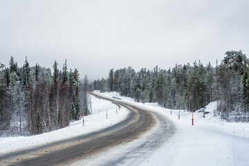 Empty snowy Northern winter road, turn on the road.