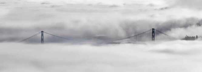 Lions Gate Bridge and Vancouver skyline in foggy morning in winter. Scenic view from Cypress Mountain. North Vancouver. British Columbia. Canada.