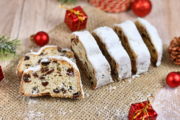 Fototapeta na wymiar Traditional German christmas season sweet food called 'Stollen' or 'Christstollen', a fruit bread of nuts, spices, and dried or candied fruit, coated with powdered sugar