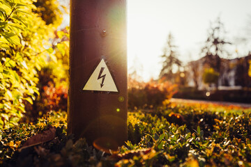 high voltage sign on a pole in the park