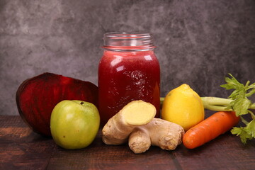 Delicious healthy red Smoothie with many fruits on wooden table,