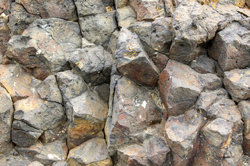 Natural stone wall with fragments protruding to the viewer in Antarctica
