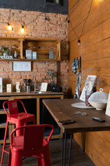 Home kitchen decor in retro style. Brick wall. Wooden shelves and table