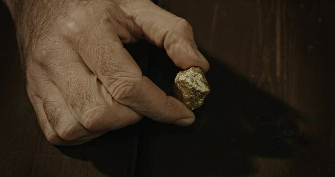 Hand holding gold nugget