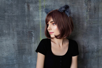 Portrait of a young attractive girl wearing cat ears