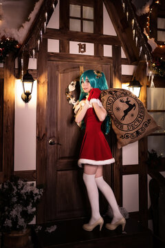 Cute girl cosplaying Christmas Miku santa dress