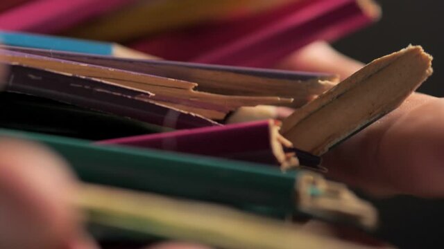 Broken crayons in hands. A metaphor for no idea, domestic violence and against children. Discharge of nerves on objects, pressure from the environment and bearing it poorly.