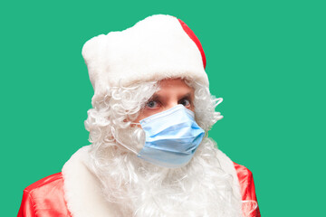 Santa Claus wears a paper Face Mask due to Covid-19. Coronavirus is dangerous and is world wide.