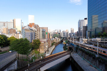 Central Tokyo. Urban cityscape, train tracks, small houses, skyscrapers made out of glass and metal. Travel concept.
Tokyo, Japan.