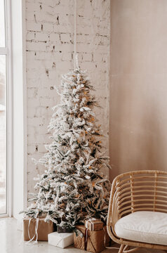 warm cozy beautiful modern design of the room in delicate light colors decorated with Christmas tree