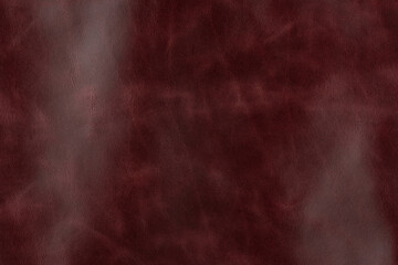 Maroon textured smooth leather surface background, small grain