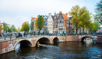 Obraz premium Amsterdam City Center. Beautiful view of Amsterdam Canals with Bridge and typical Dutch Houses. Amsterdam, Netherlands.