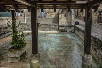 View of old Washhouse with King's Fountain (Fontaine du Roi). Washhouse - public pond (19th century), where washerwomen washed linen or rather rinsed it. Saint Emilion, Gironde, France.