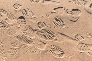 Footprints in wet sand, background texture