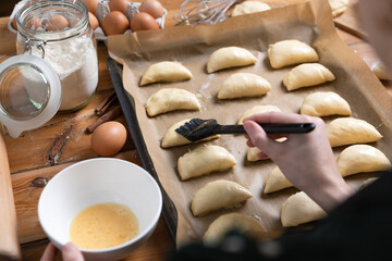 Women preparing homemade food pie, pizza in a cozzy kitchen. Hobbies and family life concept.