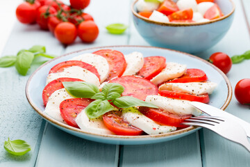 Classic caprese salad. Mozzarella tomatoes and  Basilikum.