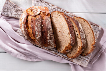 Sliced rye bread on cutting board, closeup..