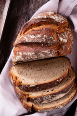 Sliced rye bread on cutting board, closeup..