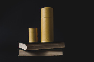 Low key chic yellow carton boxes for perfume and fragrance without label, placed on an old book