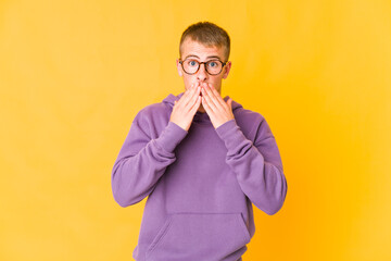 Young caucasian handsome man shocked covering mouth with hands.