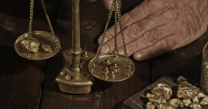 Man weighting gold nuggets with precision scale