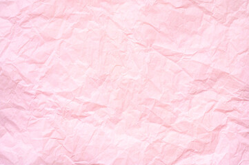 Pink paper background. Crumpled pink paper texture. Focusing in the center of the frame.
