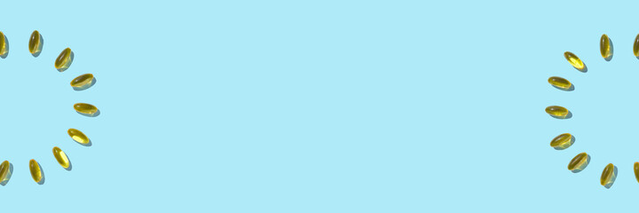 Omega3 gel capsule. Yellow vitamin. Health eating. Dietology drug. Fish oil supplement. Cirlce concept. Golden color softgel collagen. Blue background. Medicine immunity cosmetics