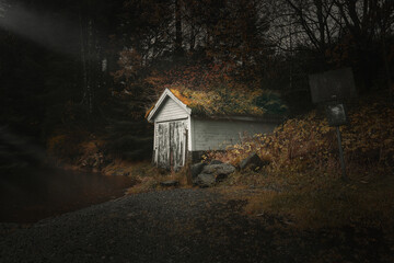 Old boat house by a lake in the woods