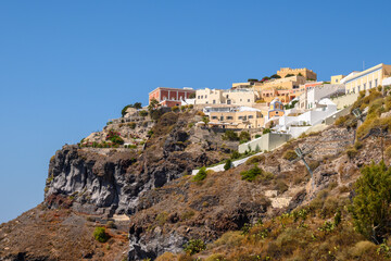 Fototapeta na wymiar Houses on a hill in Fira on the Santorini Island. Cyclades, Greece
