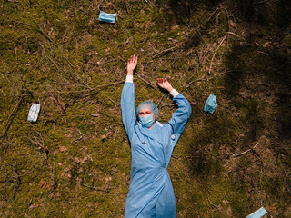 Tired female doctor or nurse rests in forest after exhausting shifts