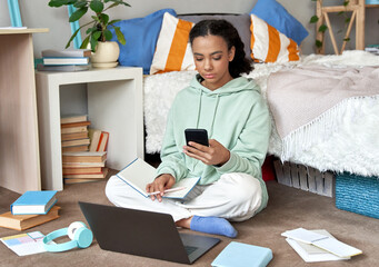Mixed race teen school girl distant school or college student virtual remote e learning using...
