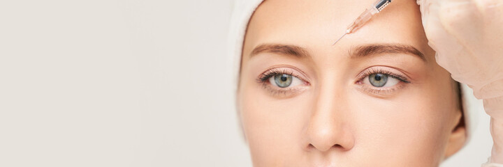Near eye injection at spa salon. Doctor hands. Closeup. High quality. Pretty female patient. Beauty...
