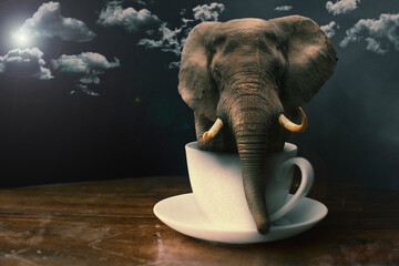 Elephant in coffee cup on wooden table