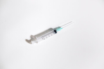 Syringe with intramuscular needle on white background. Medical concept. Copy space