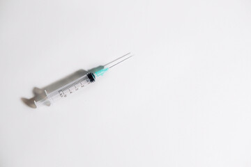 Syringe with intramuscular needle on white background. Medical concept. Copy space