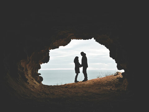 Romantic couple standing in front of the seascape. Picture of a proposal with text space