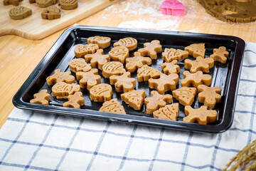 Homemade Christmas ginger bread cookies, Xmas gingerbread cookie on tray, preparing bakery, process of baking and cooking at home