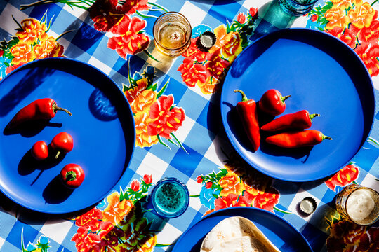 Overhead view of red chili pepper served on table with drinks and tortillas