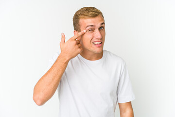 Young caucasian handsome man showing a disappointment gesture with forefinger.