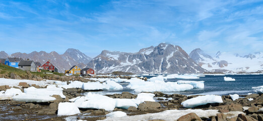 Greenland scene with icebergs, mountains and colorful, small homes.  © ChristyLangPhotos