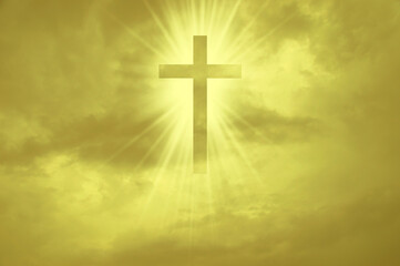 Christian cross appears bright in the yellow sky background