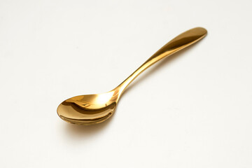 Top view of golden spoon and fork isolated white background.