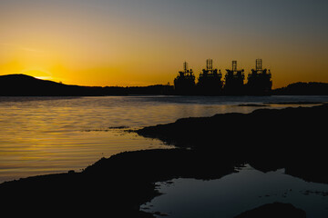 Silhouette of vessels at sunset