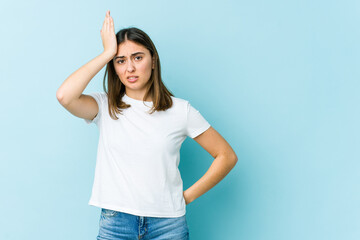 Young caucasian woman forgetting something, slapping forehead with palm and closing eyes.