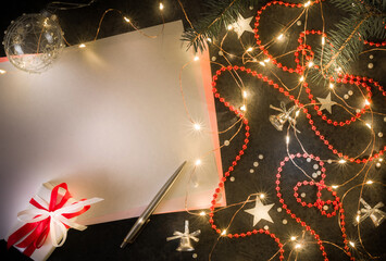 Preparation for New Year's or Christmas greetings. Dark background, girlyadna and christmas decorations. - 396661822