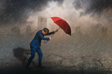 Young asian businessman standing holding red umbrella protection,rain and storm,sky and black...