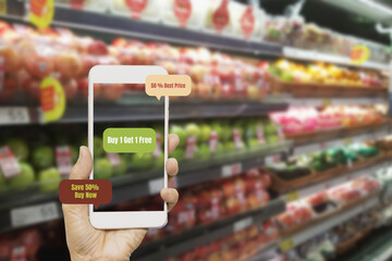 Woman using smartphone to check prices for merchandise and products on blurred supermarket shelves,Augmented Reality Or AR in Retail Business,with smartphone Concept,and futuristic application