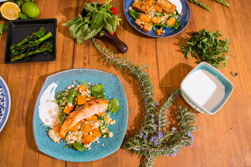 Grilled vegetables and healthy food dishes on a fancy wooden table. Mediterranean food dishes with asparagus, tofu, seitan and Halloumi cheese. Gluten free recipes for fitness persons. Food Background