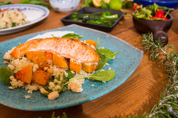 Grilled vegetables and healthy food dishes on a fancy wooden table. Mediterranean food dishes with asparagus, tofu, seitan and Halloumi cheese. Gluten free recipes for fitness persons. Food Background